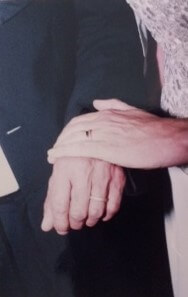 Close-up of bride and groom's hands.