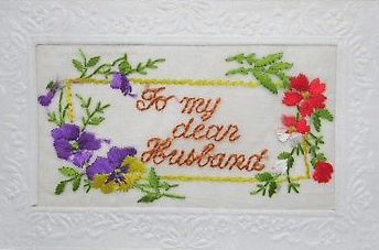 Embroidered postcard reading For my dear husband, with flowers.