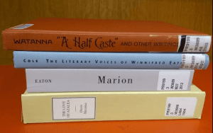 Pile of library books by and about Winnifred Eaton.