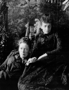 Posed photograph of Selma Lagerlof leaning against Sophie Elkan.