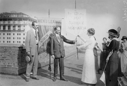 Photograph of Frances Maule Bjorkman with a suffragist banner.