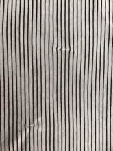 Closeup of portion of striped shirt with inexpert darning.