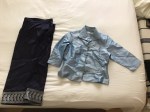 Wrinkled Lao blouse and skirt on bed.