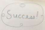 Handwritten word Success! with squiggles.