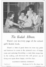 1919 Kodak ad, girls looking at photo album.