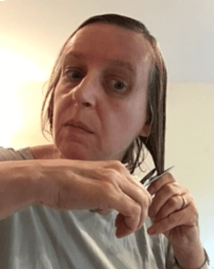 Mary Grace McGeehan cutting hair, May 1920.